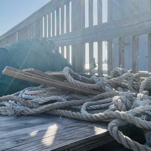 Rope and fishing nets on a weathered dock at Pier 19 in Galveston
